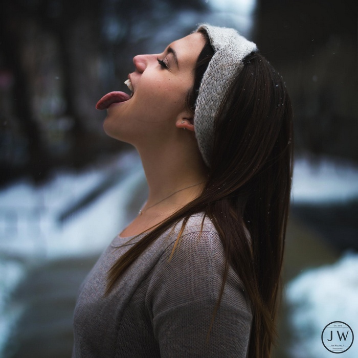 Woman sticking her tongue out in the snow