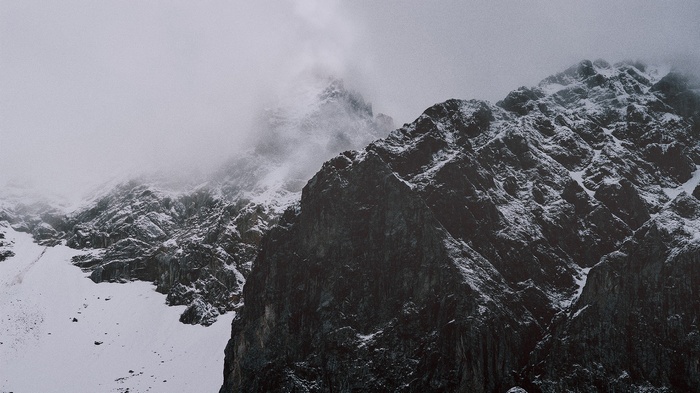 Snow-covered mountains shrouded in mist
