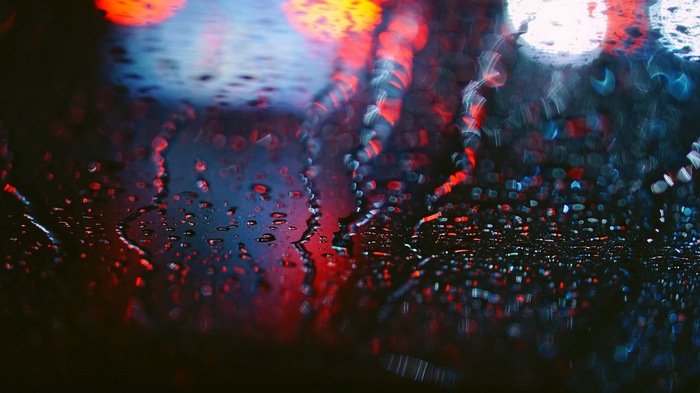 Raindrops on glass with bokeh lights