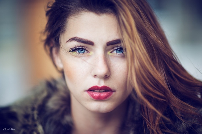 Portrait of a woman with blue eyes and red lipstick