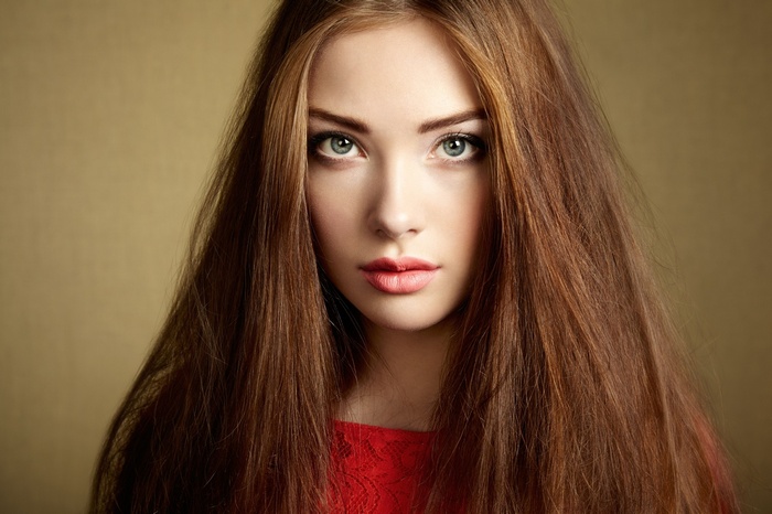 Woman with long brown hair and red top