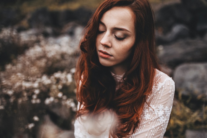 Woman with red hair and freckles outdoors