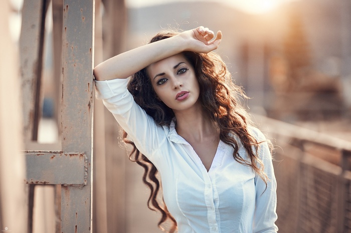 Woman with long curly hair outdoors