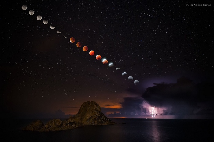 Lunar Eclipse Over Ocean with Lightning and Stars