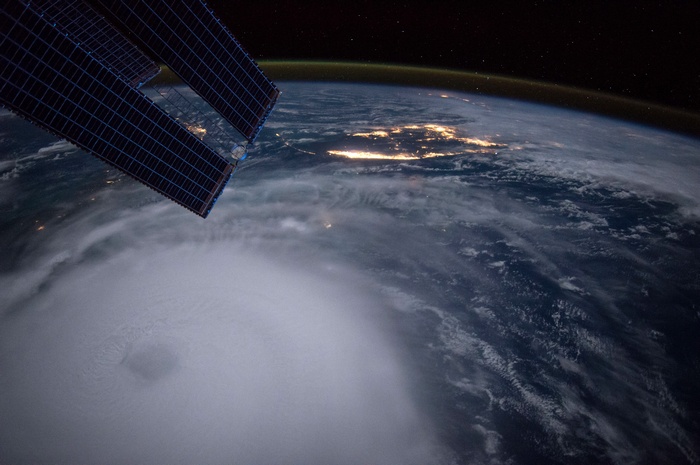 Earth from space with a hurricane and solar panels