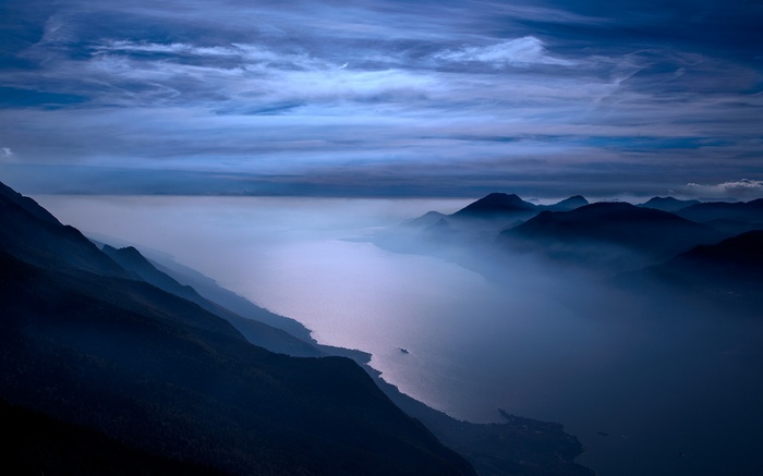 Mountains and lake shrouded in mist