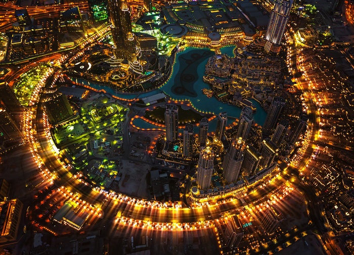 Dubai cityscape with illuminated skyscrapers and water features at night