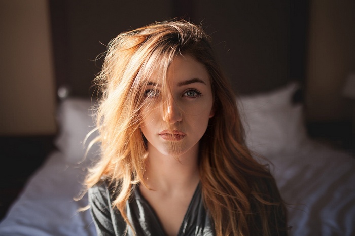Woman with blonde hair in a dark room