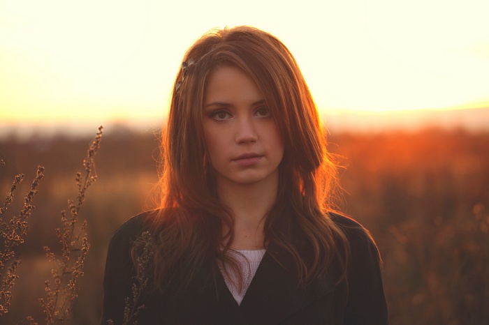 Ksenia Kokoreva in a field at sunset