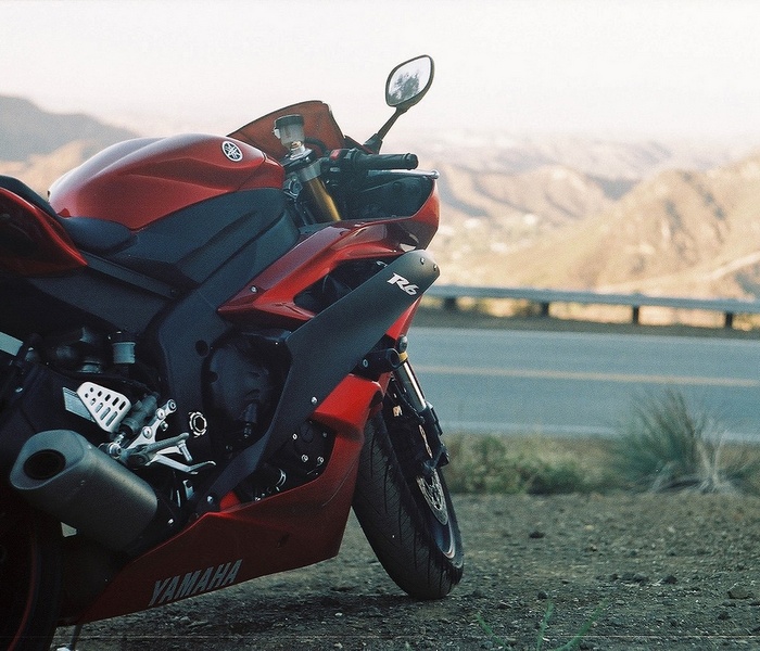 Red Yamaha R6 motorcycle parked on a roadside