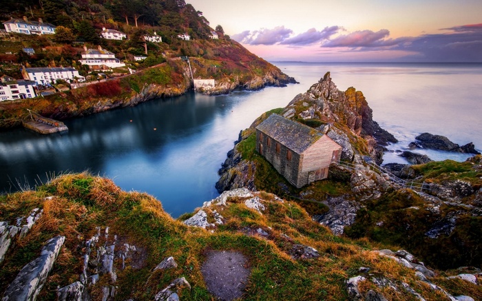 Coastal village with a boathouse on a rocky outcrop