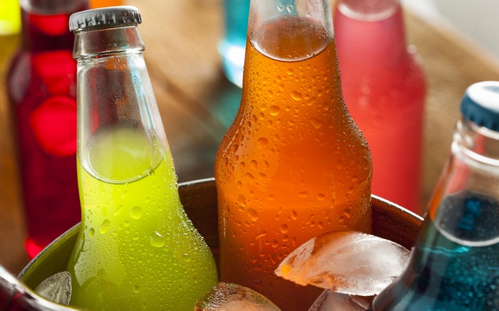 Assorted colorful soda bottles in ice
