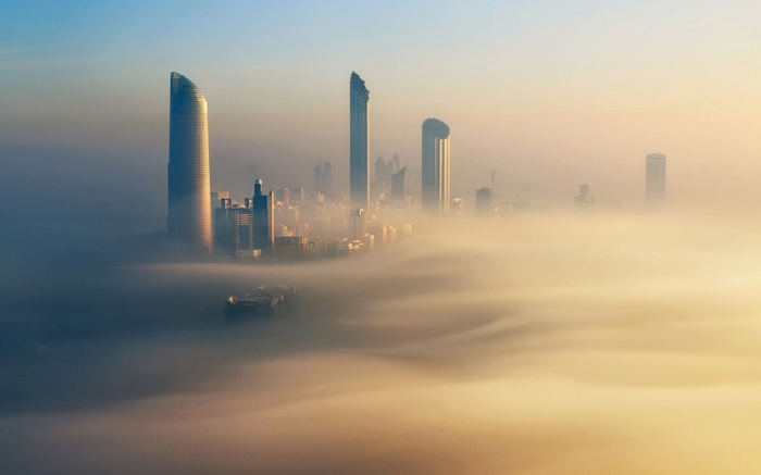 Cityscape of Abu Dhabi shrouded in fog