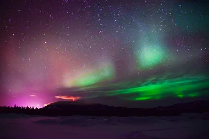 Aurora Borealis over a snowy landscape