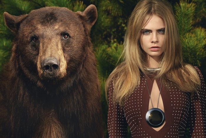 Cara Delevingne and a bear in a forest