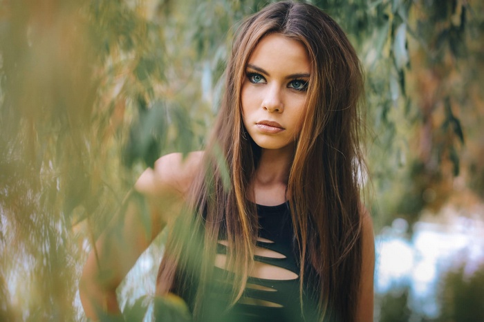Woman with long brown hair in a black top