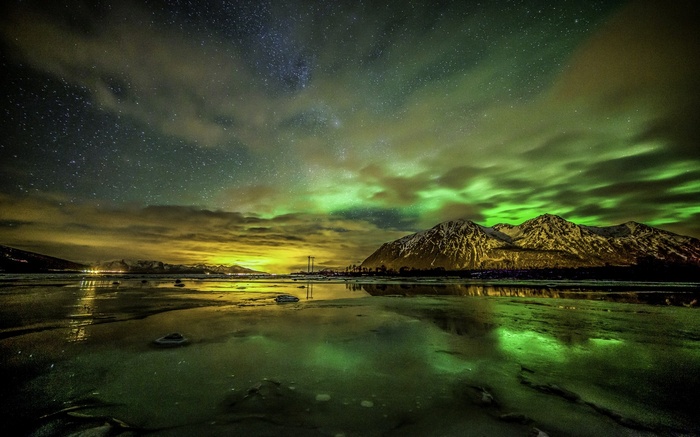 Aurora Borealis over snowy mountains in Norway