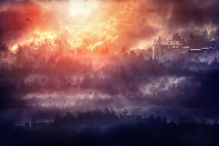 Castle on a misty mountain at sunset