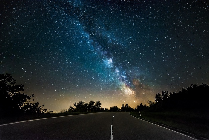 Milky Way over a road at night