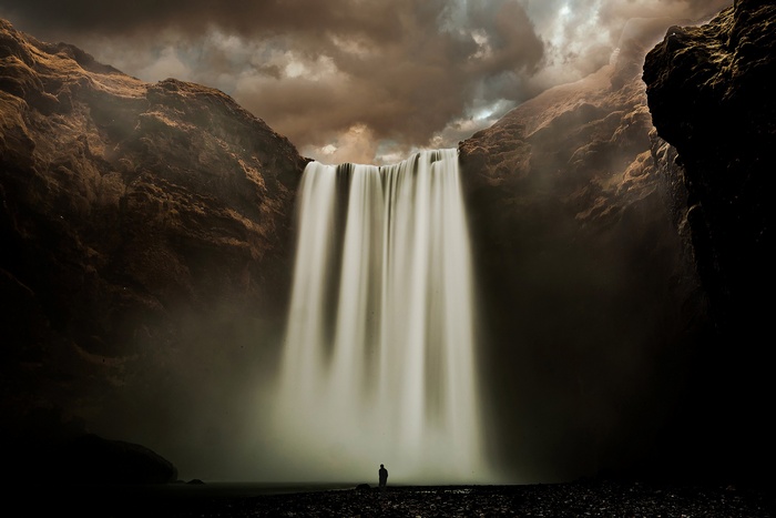 Silhouette in front of Skogafoss waterfall in Iceland