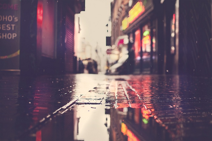 Rainy street with neon reflections in an urban setting