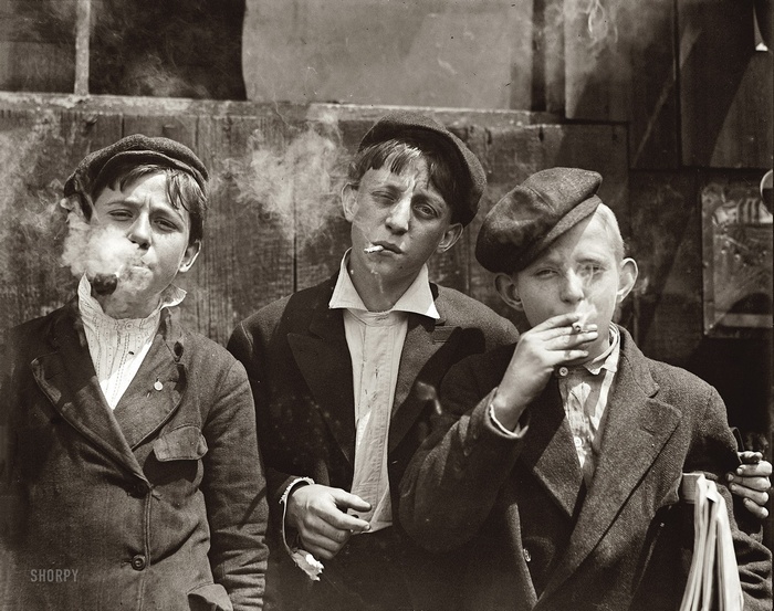 Three boys smoking pipes and cigarettes