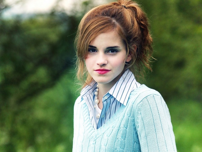 Emma Watson wearing a blue sweater and white shirt