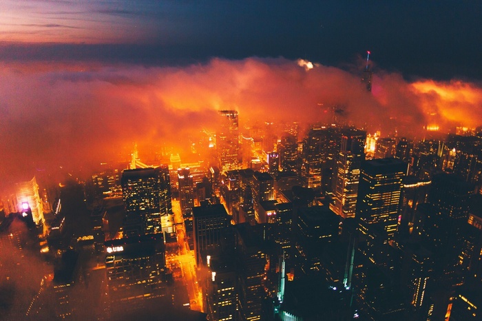 City skyline at night with orange clouds