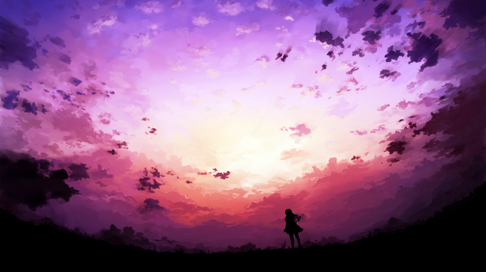Girl silhouetted against a vibrant sunset sky
