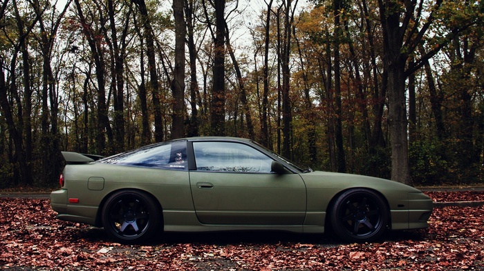 Nissan 180SX parked on a leaf-covered road