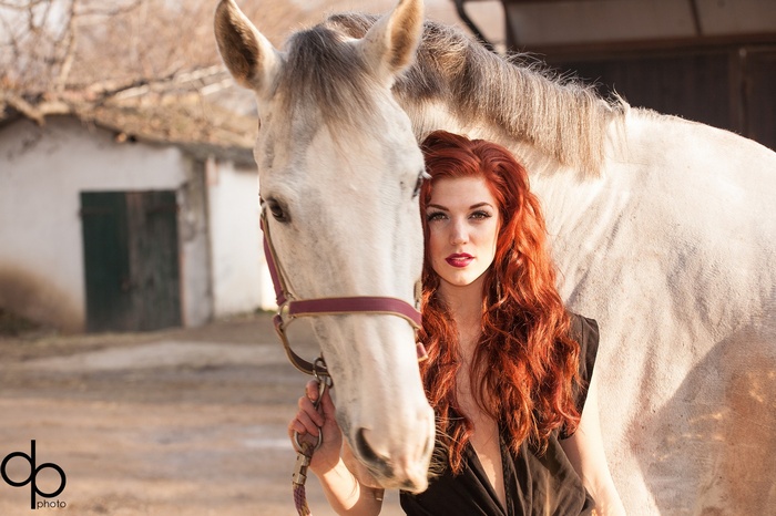 Redhead woman with a white horse