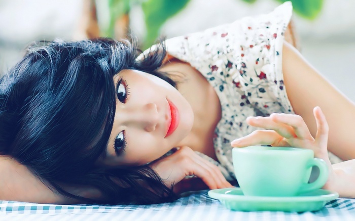 Asian woman with black hair and a floral dress