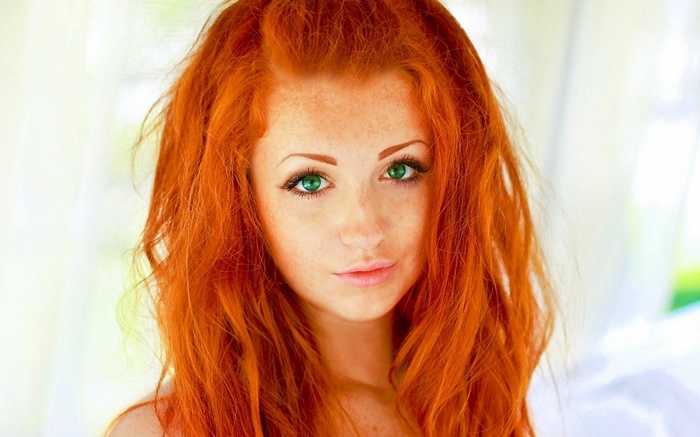 Redhead woman with green eyes and freckles