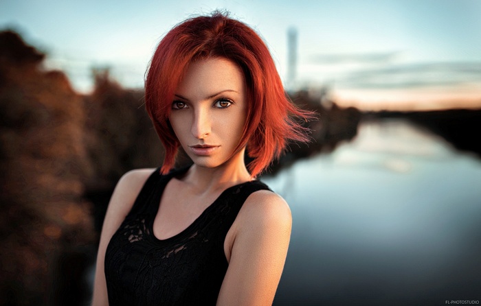 Redhead woman in black clothing with brown eyes