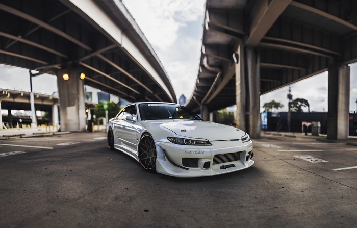 White Nissan Silvia S15 tuned car under a bridge