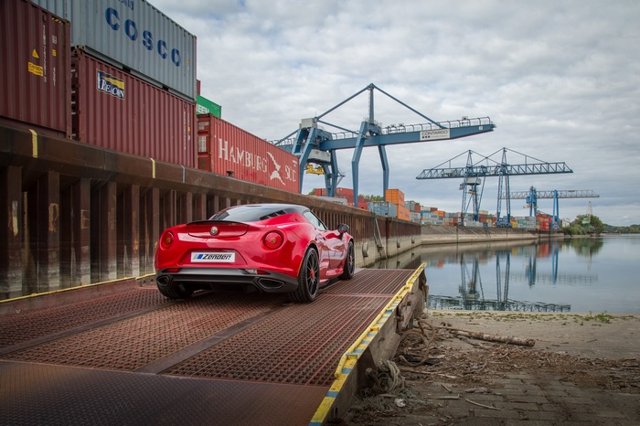 Red Alfa Romeo 4C at a Shipping Port