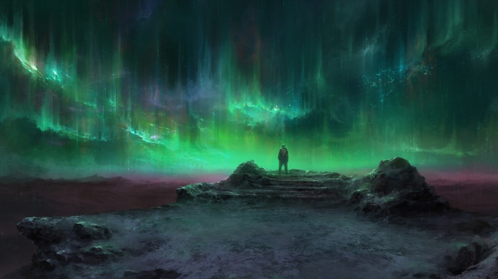 Person standing on rocks watching aurorae