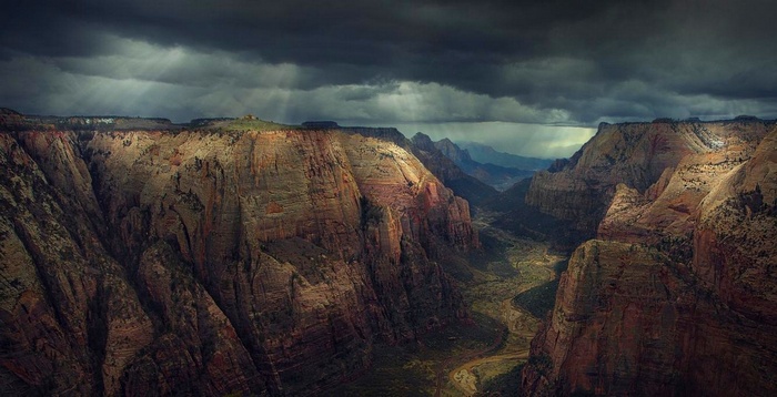Canyon with sun rays through clouds