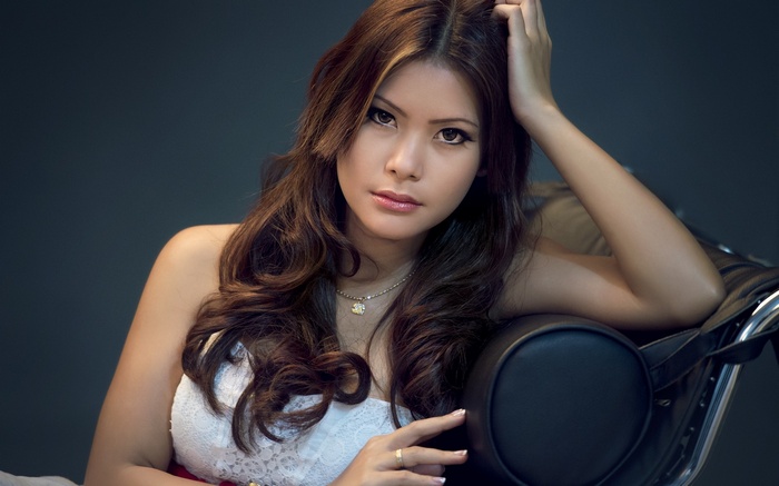 almond eyes, Asian, chair, face, necklace, hands in hair, simple background, white dress, brown eyes, brunette, looking at viewer, bare shoulders, long hair, model, women
