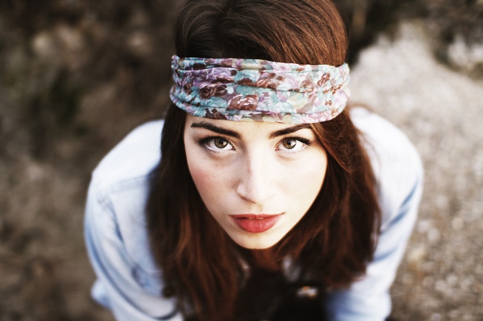 Woman with floral headband looking up