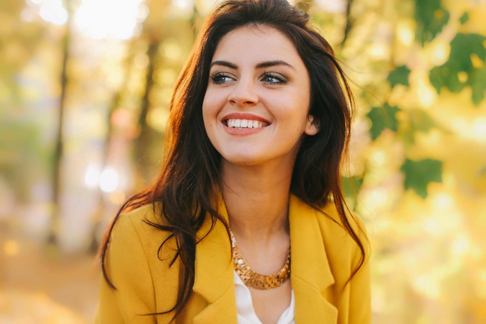 Aurela Skandaj in a yellow jacket smiling