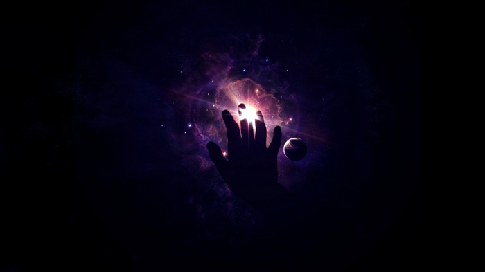 Silhouette of a hand reaching towards a bright nebula in space