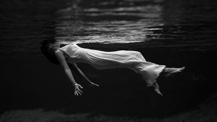 Lana Del Rey underwater in a white dress