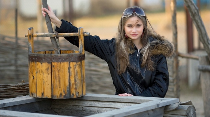 Irina Buromskih with a wooden bucket outdoors