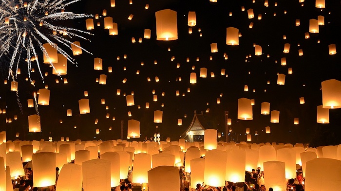 Thousands of lanterns and fireworks light up the night sky