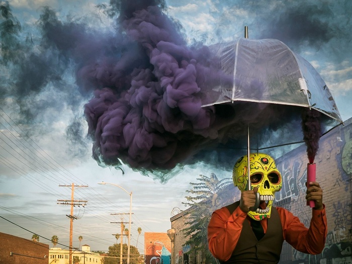 Man in Skull Mask with Umbrella and Smoke