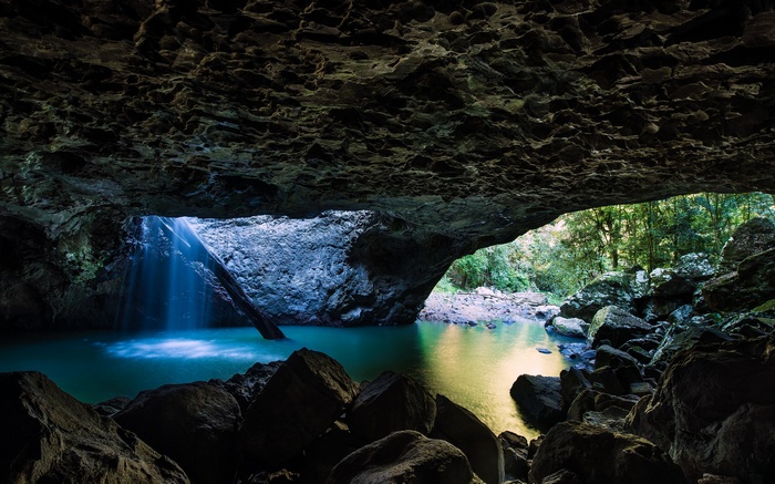 Cave with waterfall and turquoise pool in Australia