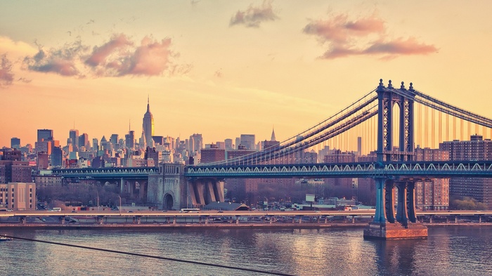 Manhattan Bridge and New York City skyline at sunset