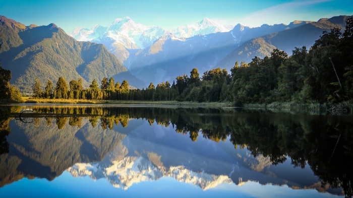 Snowy mountains reflected in a lake in New Zealand