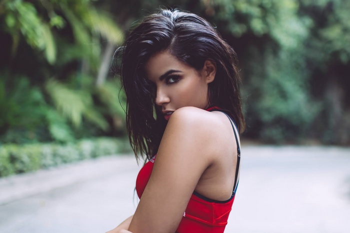 Woman with dark hair in a red top